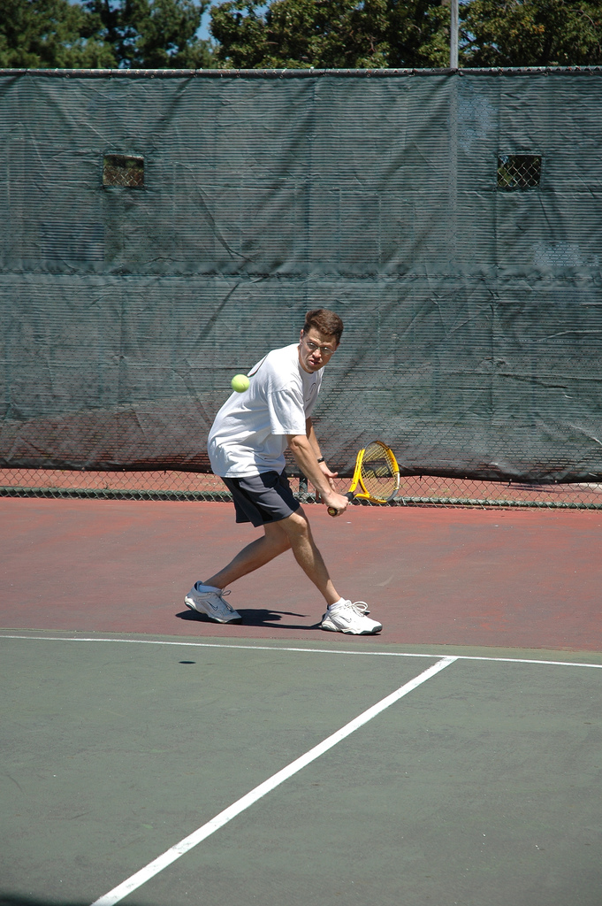 One-handed backhand of a recreational tennis player