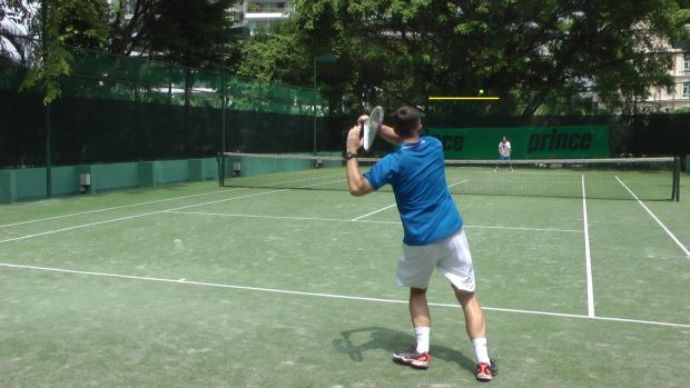 forehand high above the net