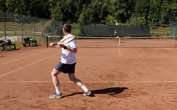 one-handed backhand in open stance 